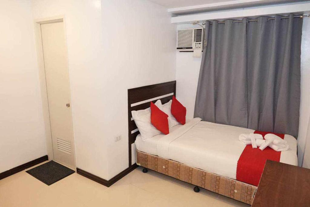 Postel nebo postele na pokoji v ubytování Ecoland 88 Apartelle & Suite