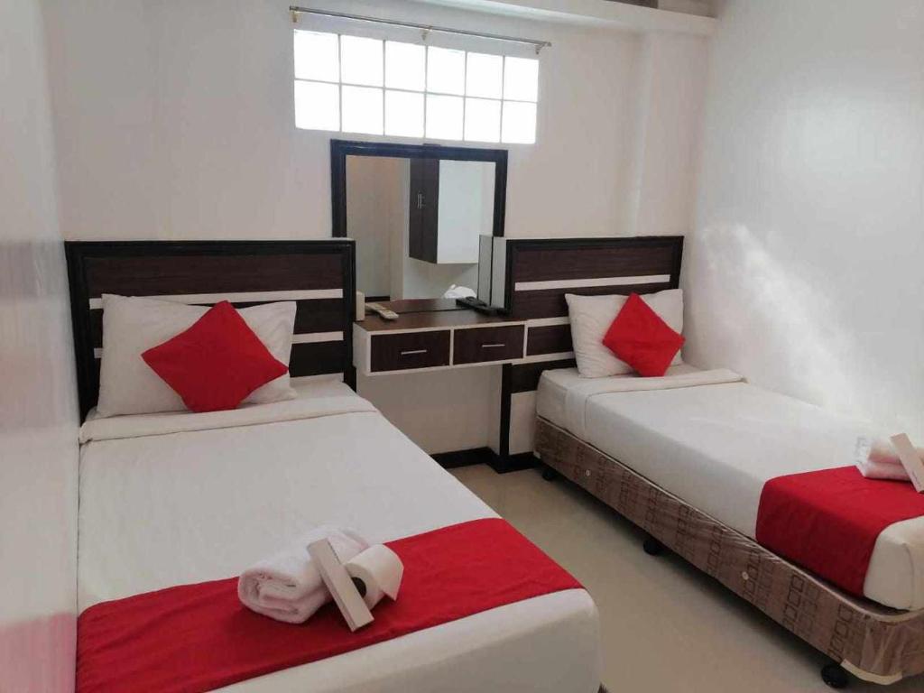 Postel nebo postele na pokoji v ubytování Ecoland 88 Apartelle & Suite