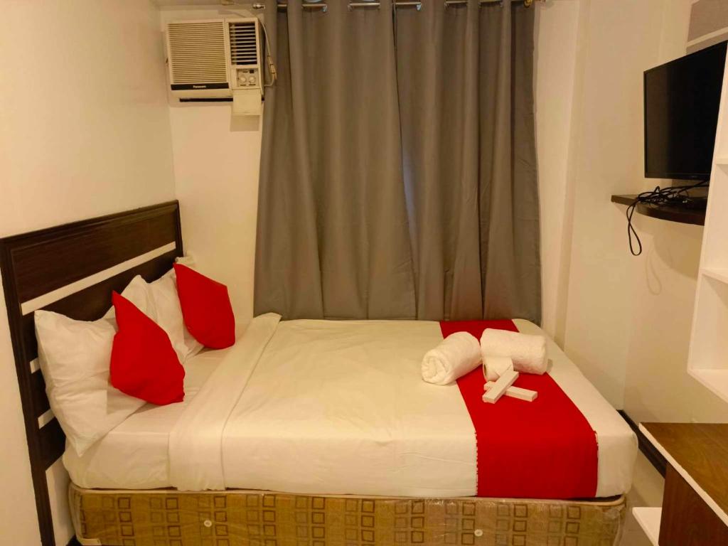 Postel nebo postele na pokoji v ubytování Ecoland 88 Apartelle & Suite