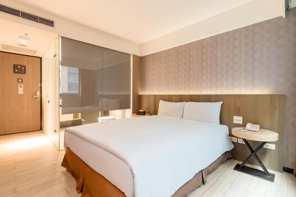Postel nebo postele na pokoji v ubytování Guide Hotel Taipei Fuxing North