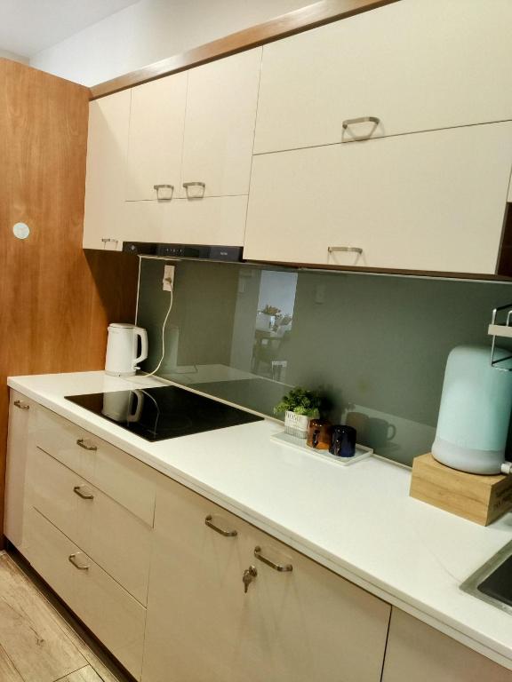 a kitchen with white cabinets and a sink at N's house in Phan Thiet