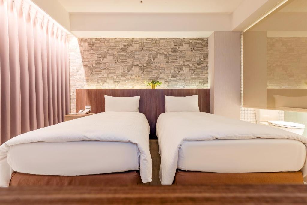 Postel nebo postele na pokoji v ubytování Guide Hotel Taipei Fuxing North