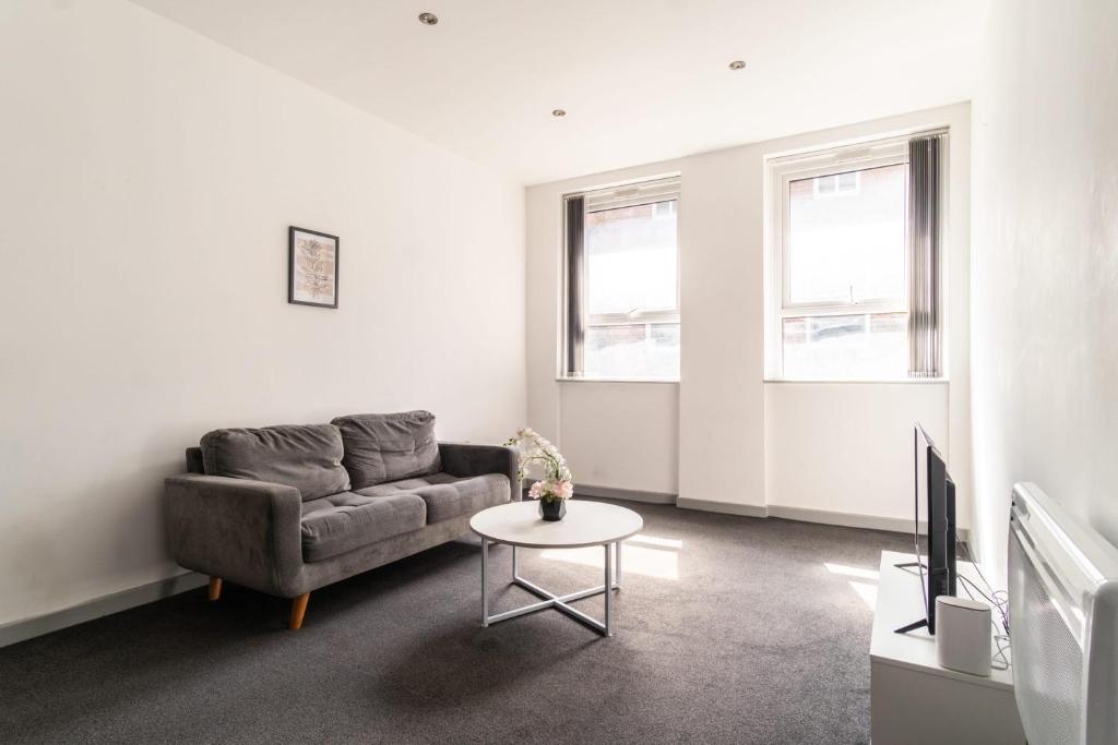 a living room with a couch and a table at Lovely 1 Bed Apartment in Central Blackburn in Blackburn