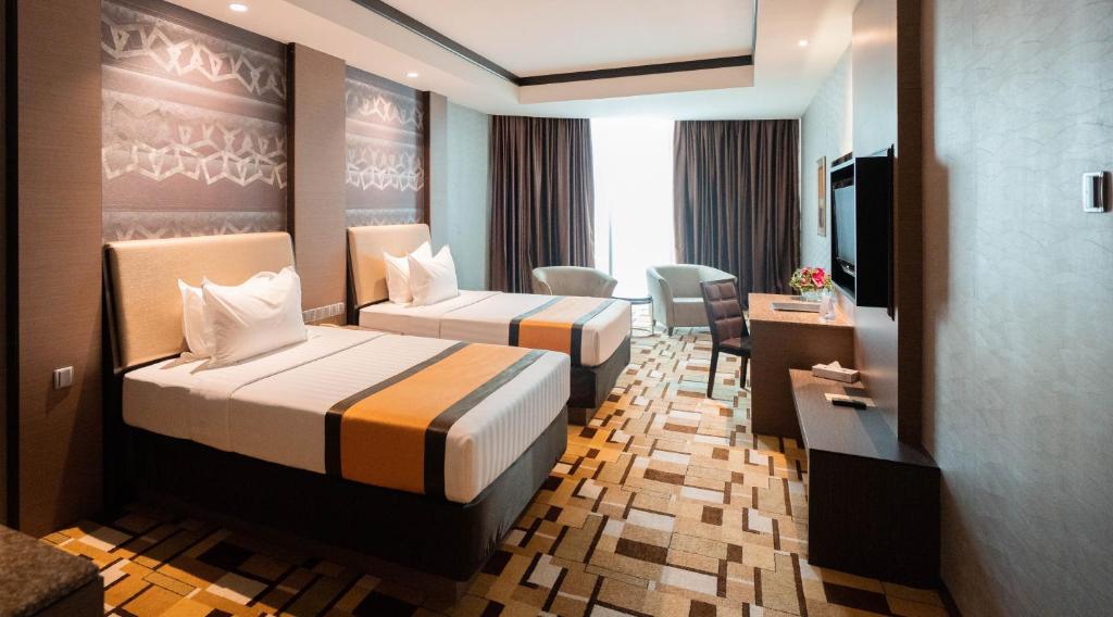 Postel nebo postele na pokoji v ubytování Grand Paragon Hotel Johor Bahru