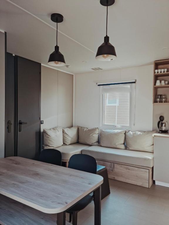 a living room with a couch and a table at Super Cordelia - Camping Belle-Vue in Berdorf