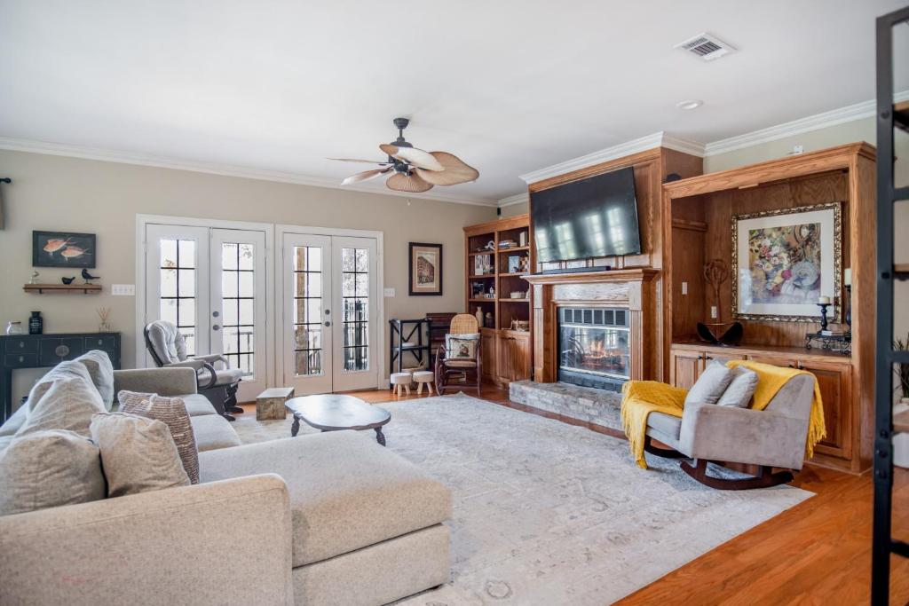 a living room with two couches and a fireplace at Stunning Riverside Retreat with Private Pool home in Port Vincent