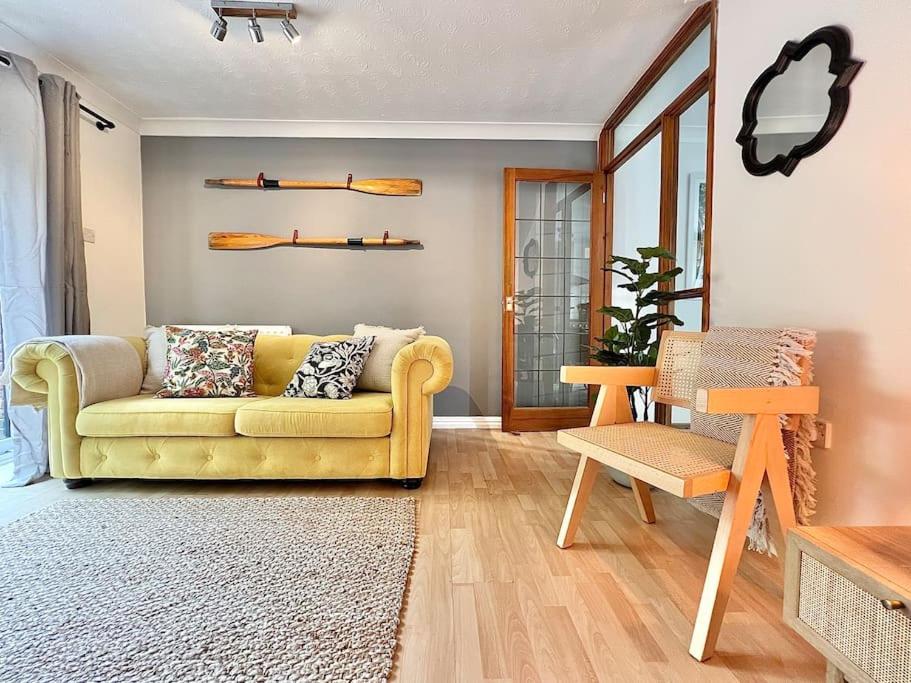 a living room with a yellow couch and a chair at Perfect Very Central and Peaceful Oxford Home with Free Parking & Private Garden - in Oxford