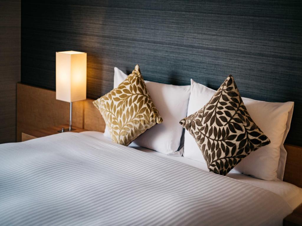 Postel nebo postele na pokoji v ubytování Hotel Resol Trinity Hakata
