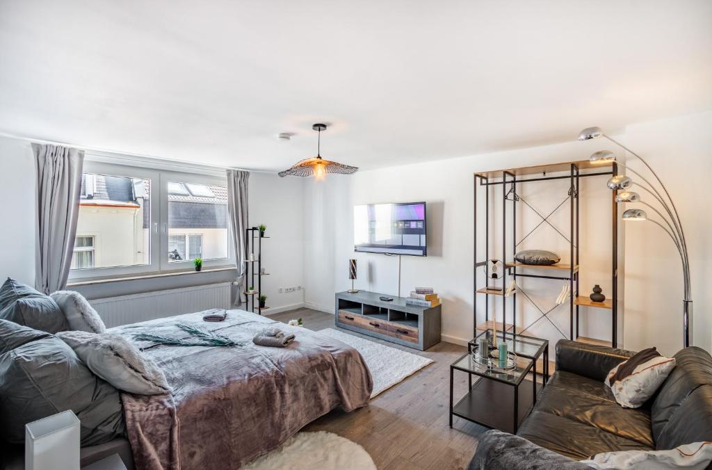 a living room with a bed and a couch at VAZ Apartment Langerfelder Auszeit, nahe 3M, Amazon und EDE in Wuppertal