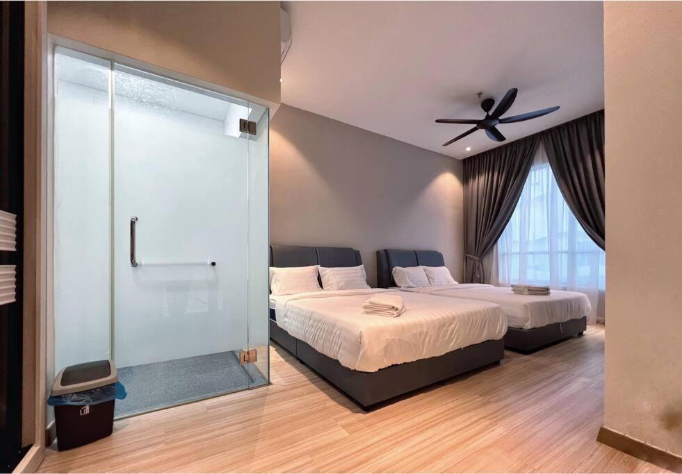 a bedroom with two beds and a ceiling fan at Melaka Penthouse 8-10 Pax 3 Rooms 3 Bathroom 2 Carparks in Malacca