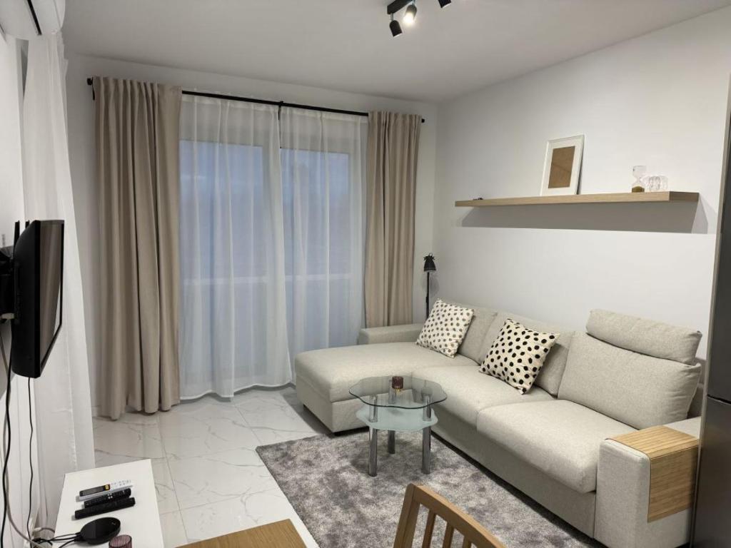 a living room with a couch and a glass table at Luksusowy Apartament in Jaworzno