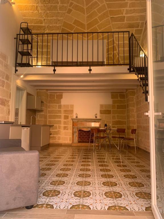 an empty room with a table and a staircase at Le Dimore del Castello in Nardò
