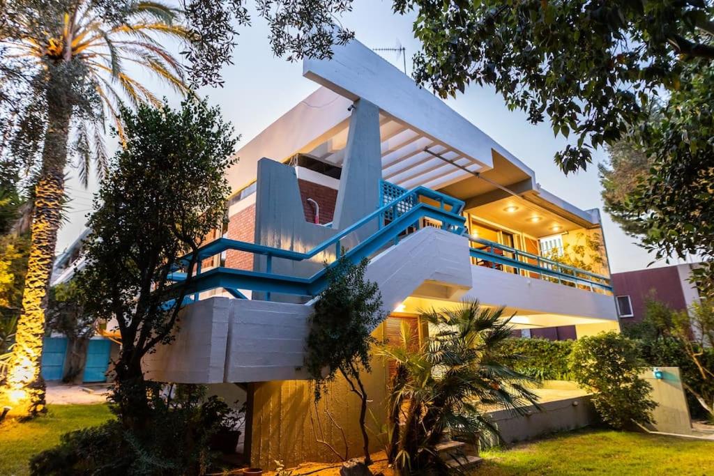a house with a staircase in front of it at Retro House in Rafina