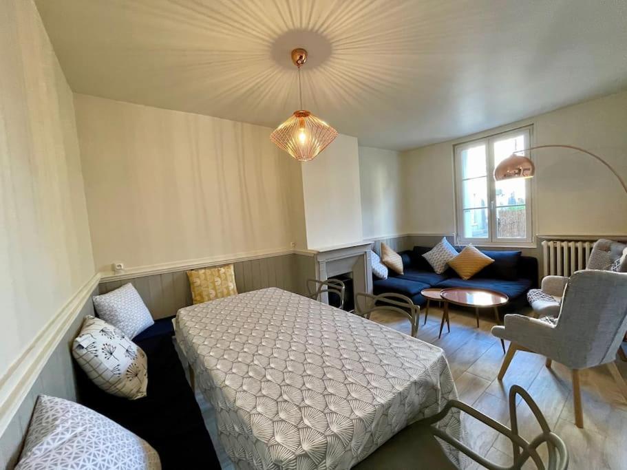 a bedroom with a bed and a living room at Jolie maison avec jardin a 100m de la plage in Étretat