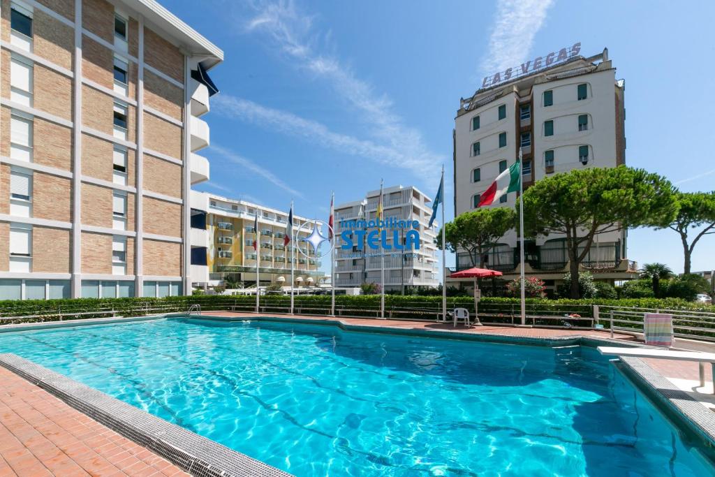 a large swimming pool in front of two buildings at Residence Vera Cruz in Lido di Jesolo