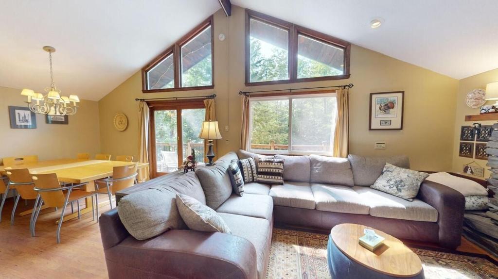 a living room with a couch and a table at Dean Hill Chalet Brought to you by GetAway Vacations in Killington