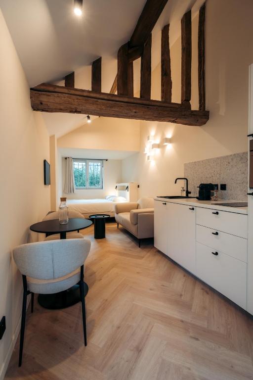 une cuisine et un salon avec un canapé et une table dans l'établissement La Salamandre, à Fontainebleau