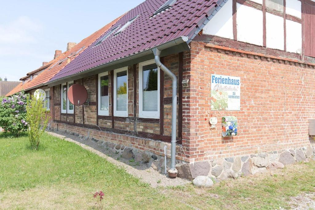 a brick building with a sign on the side of it at Ferienhaus Schnitterkarten - nur an Feriengäste - ABC366 in Klütz