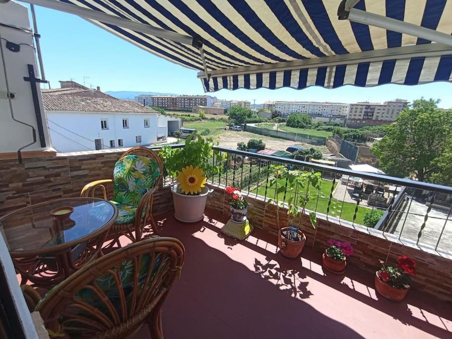 a balcony with a table and chairs and a view at La Casita de Ivanna in Fuenmayor