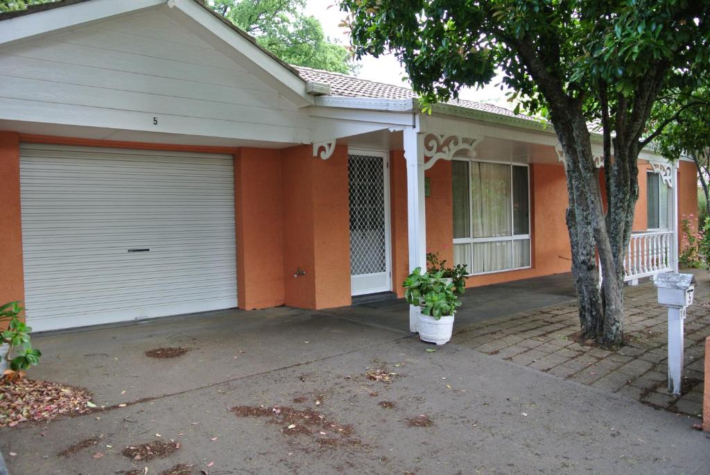 a house with a garage door and a tree at Onocay House in Bright