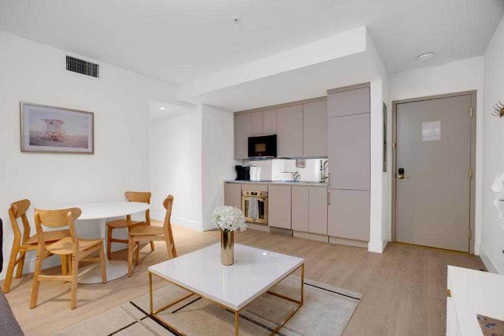 a living room with a table and chairs and a kitchen at Vonder Miami Beach - Unit 6 in Miami Beach