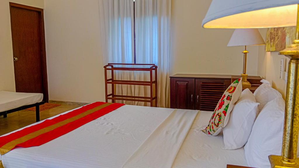 Postel nebo postele na pokoji v ubytování Sigiri Lanka Resort