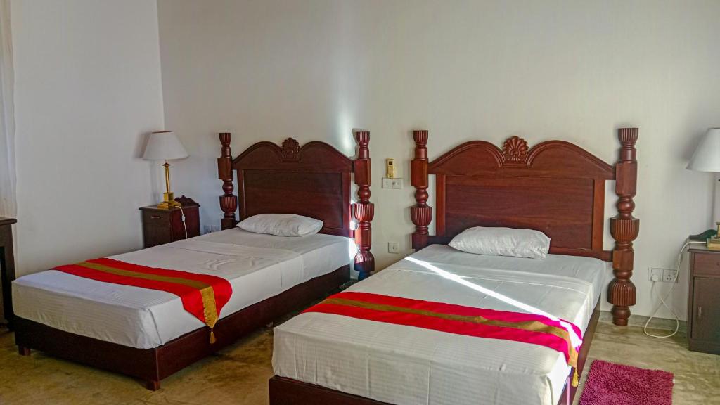 Postel nebo postele na pokoji v ubytování Sigiri Lanka Resort