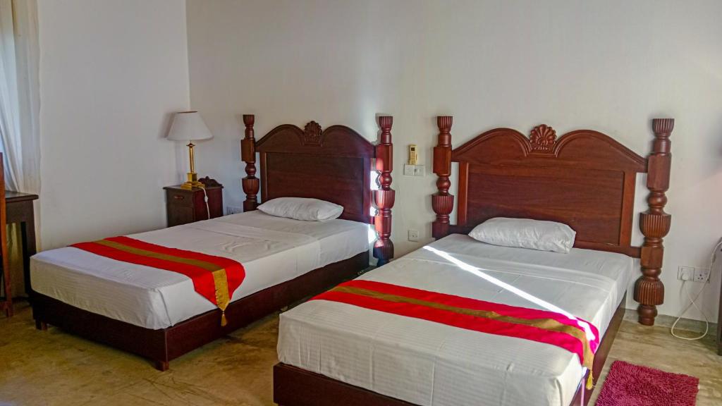 Postel nebo postele na pokoji v ubytování Sigiri Lanka Resort