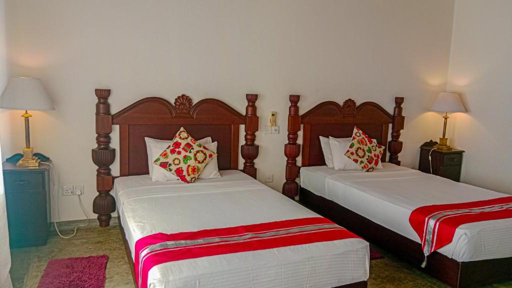 Postel nebo postele na pokoji v ubytování Sigiri Lanka Resort