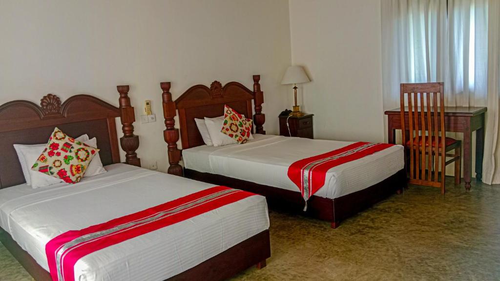 Postel nebo postele na pokoji v ubytování Sigiri Lanka Resort