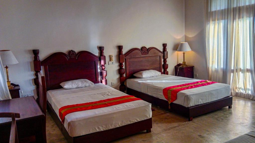 Postel nebo postele na pokoji v ubytování Sigiri Lanka Resort
