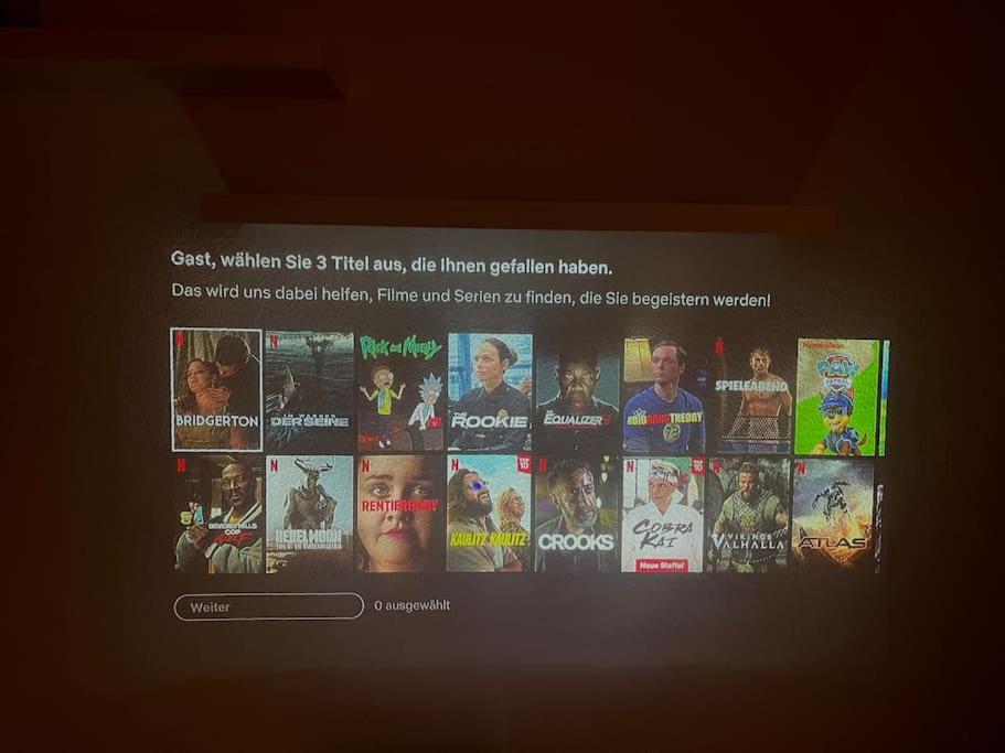 a television screen with a bunch of movies on it at Stilvolle Wohnung in Offenburg in Offenburg