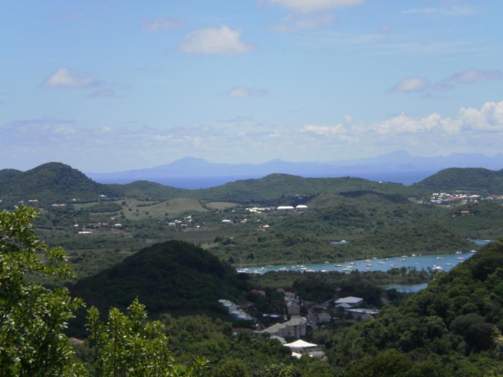 uma vista para um vale com um rio e montanhas em Abri Gens Libres em Le Marin