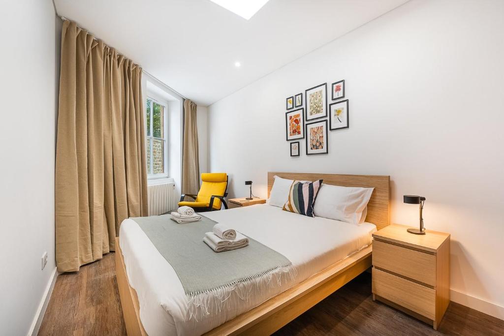 a bedroom with a large bed and a window at GuestReady - Serene Hideout in Downtown in Porto