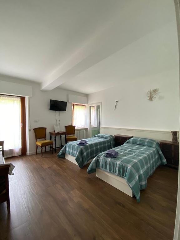 Łóżko lub łóżka w pokoju w obiekcie B&B Panorama Dolomiti