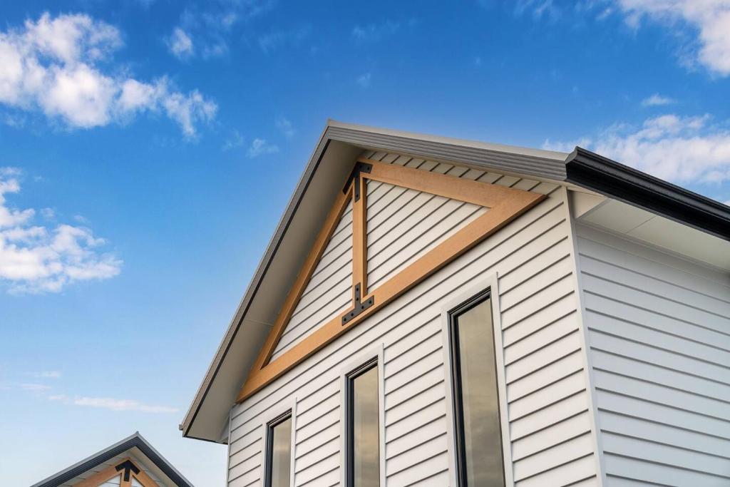a white house with a gambrel roof at Central brand new studio in Beechworth