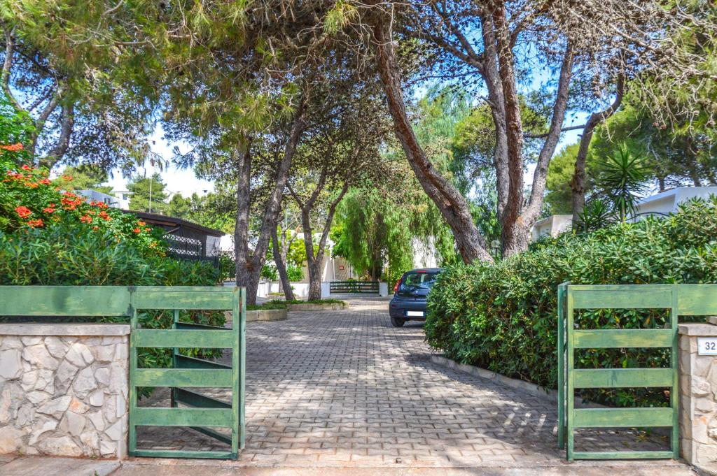 a car parked on a brick road with trees at Villetta Pinetata 452 in Ugento