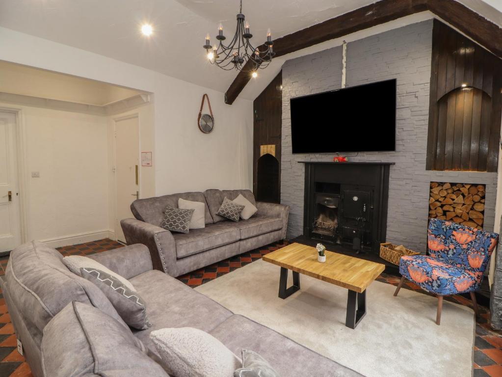 a living room with a couch and a fireplace at The Furness Haven in Barrow in Furness