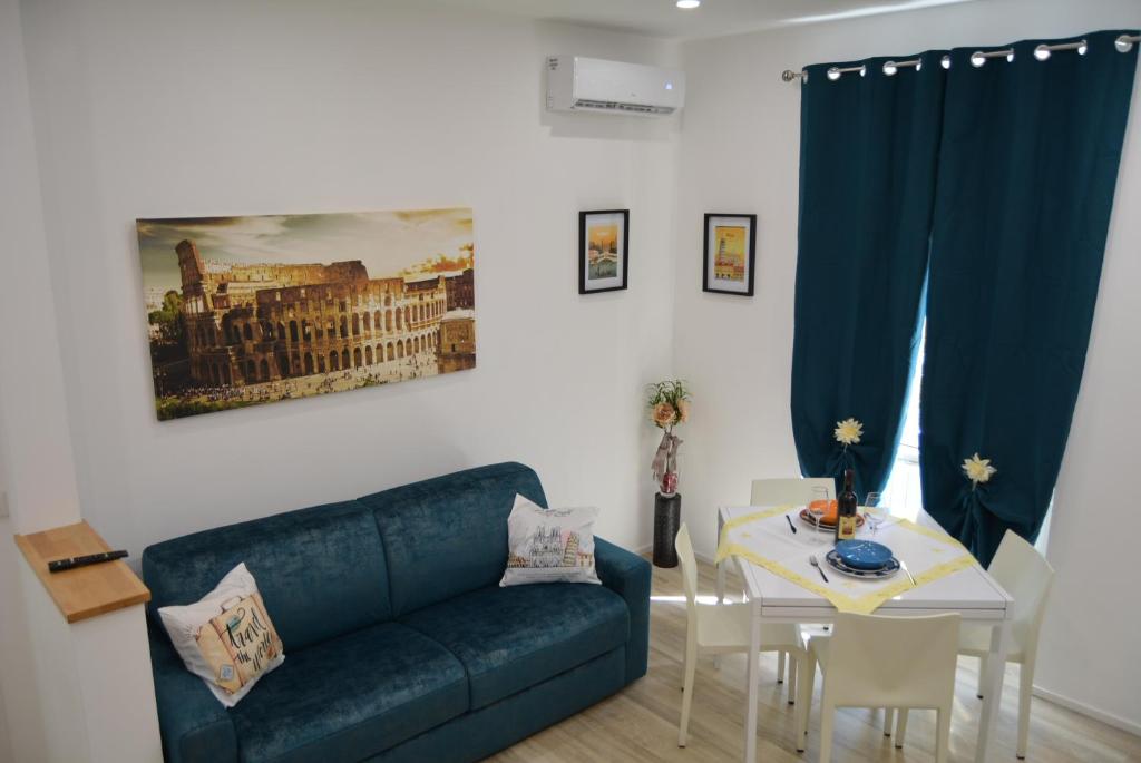 a living room with a blue couch and a table at Casa Amabile in Rome