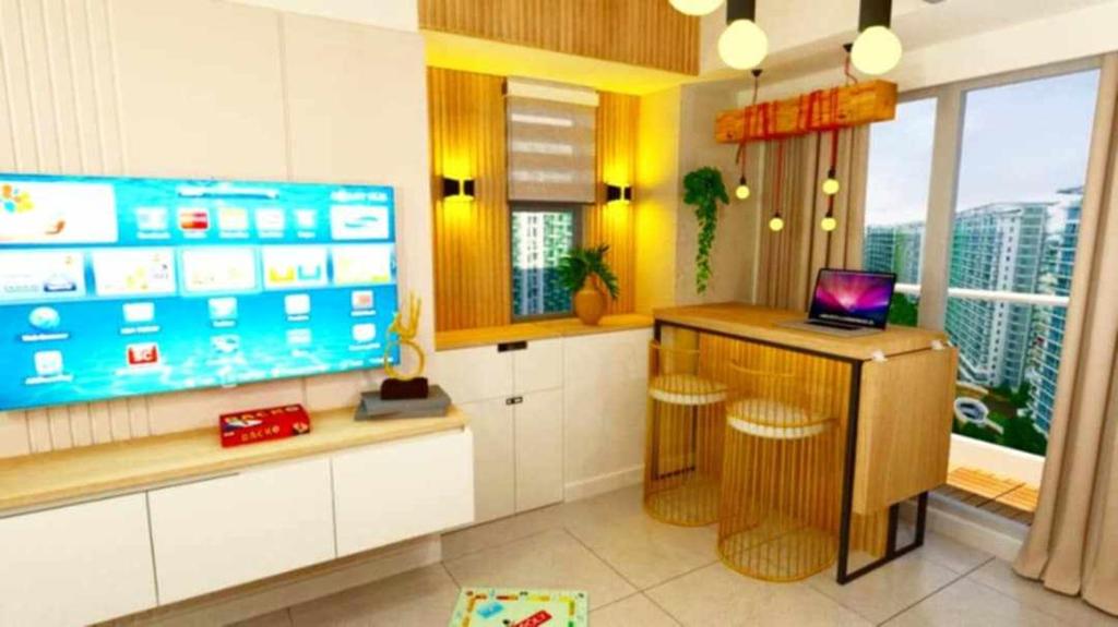 a room with a laptop on a counter with a window at Manila Urban Resort at Azure in Manila
