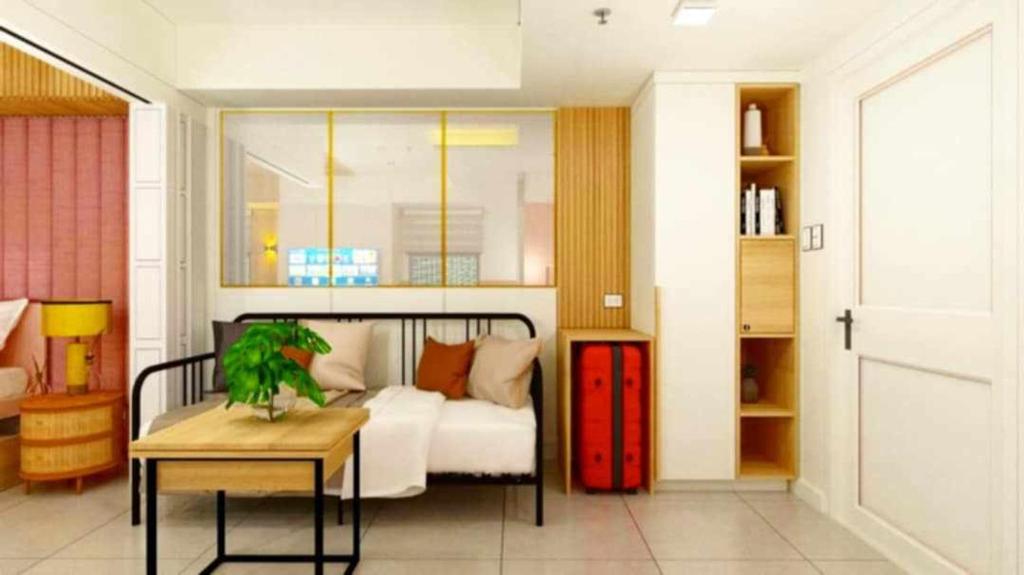 a bedroom with a bed and a table and a table sidx sidx sidx at Manila Urban Resort at Azure in Manila