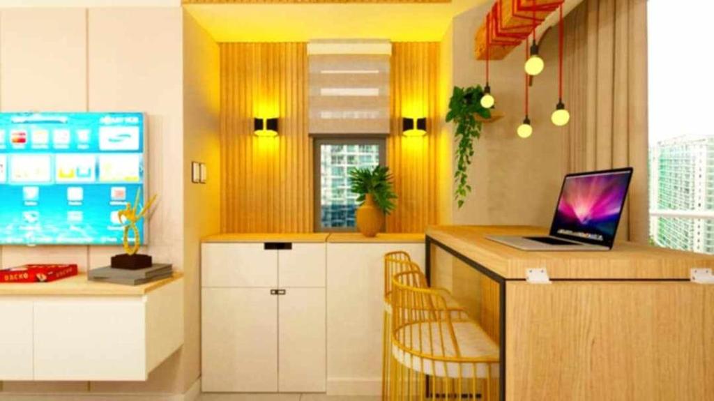 a kitchen with a desk with a laptop on a counter at Manila Urban Resort at Azure in Manila
