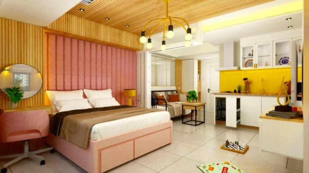a bedroom with a large bed and a kitchen at Manila Urban Resort at Azure in Manila