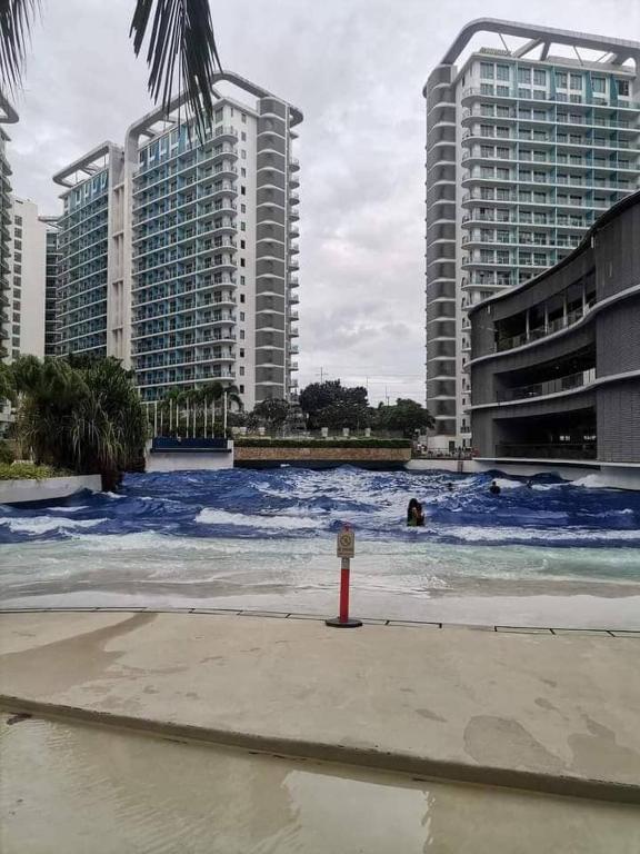 a large body of water with buildings in the background at Manila Urban Resort at Azure in Manila