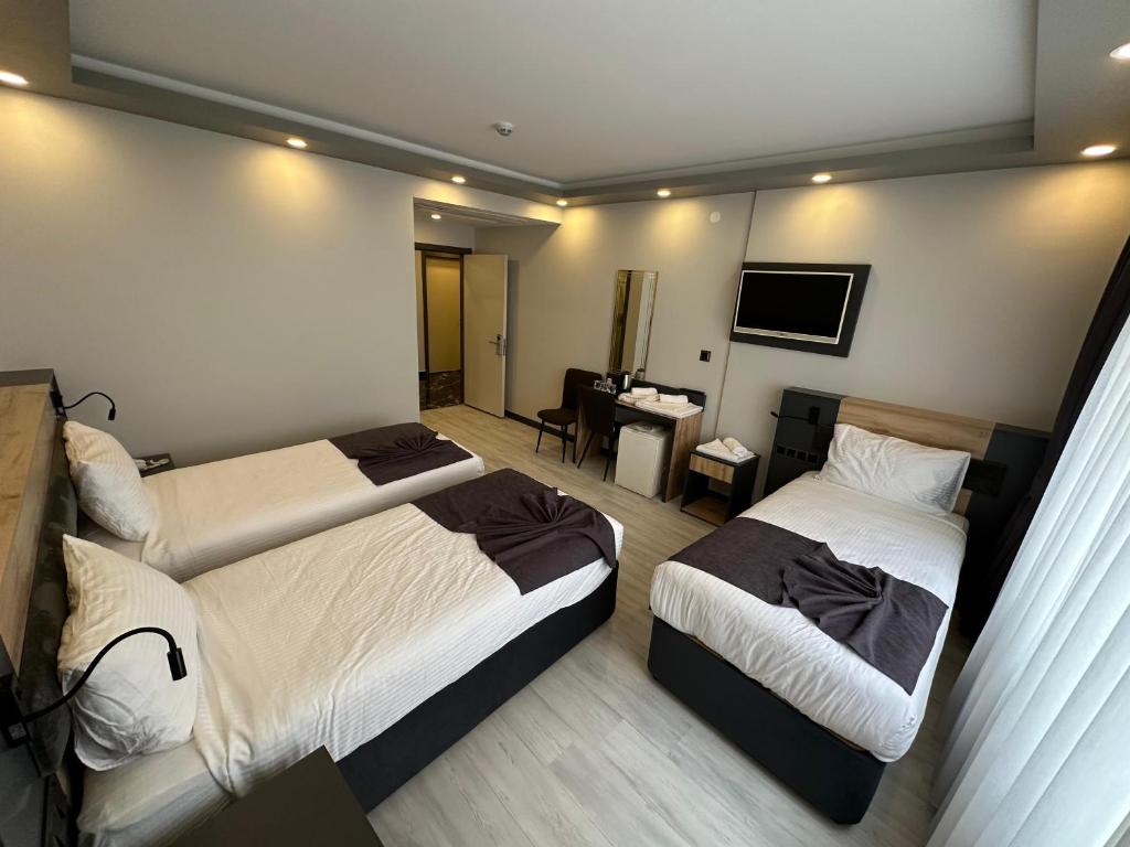 Postel nebo postele na pokoji v ubytování Ofpark Otel