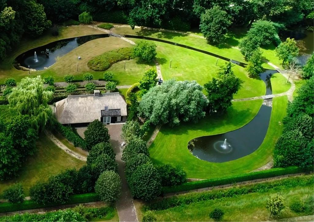 an aerial view of a park with a house and a pond at Stunning Catena Property in Boxtel