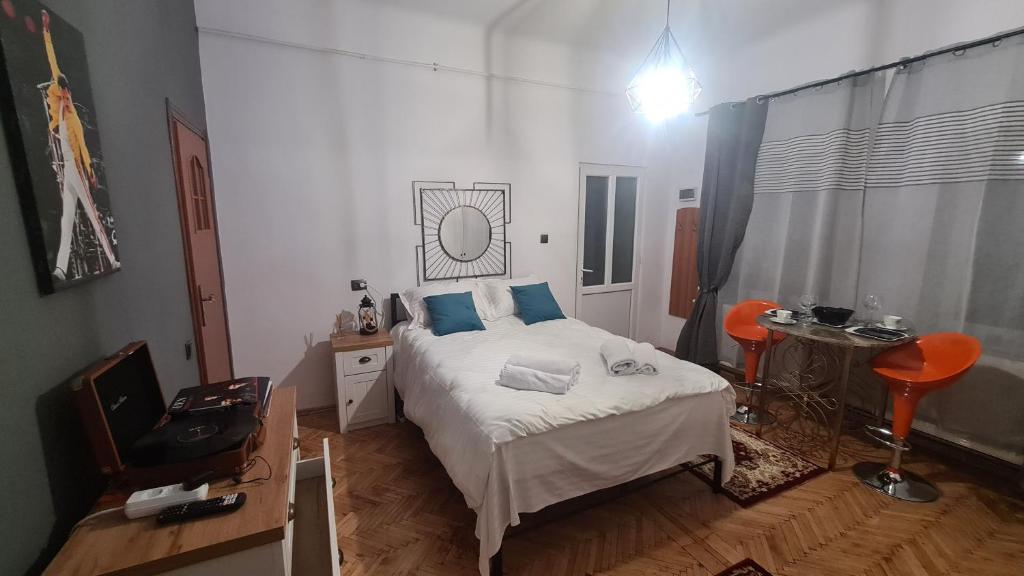 a bedroom with a bed with blue pillows on it at Cozy studio in noble house main square in Cluj-Napoca