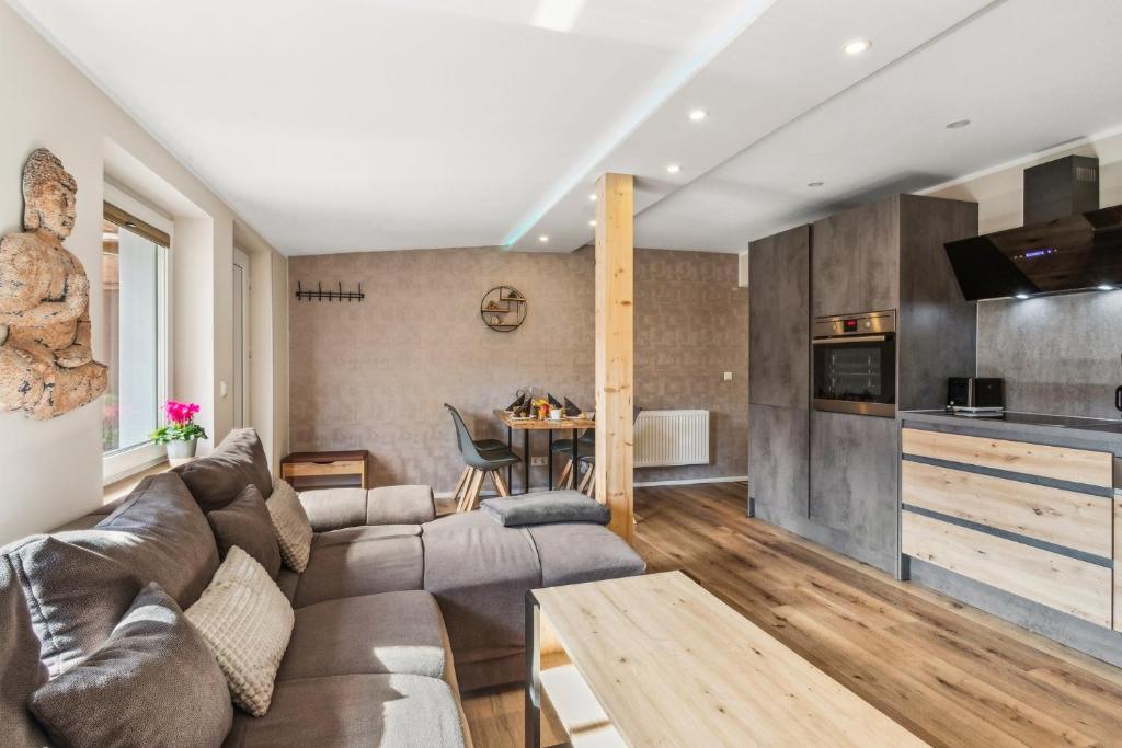 a living room with a couch and a table at Garten - Bergblick - SmartTV - Parkplatz - HarzLounge in Thale