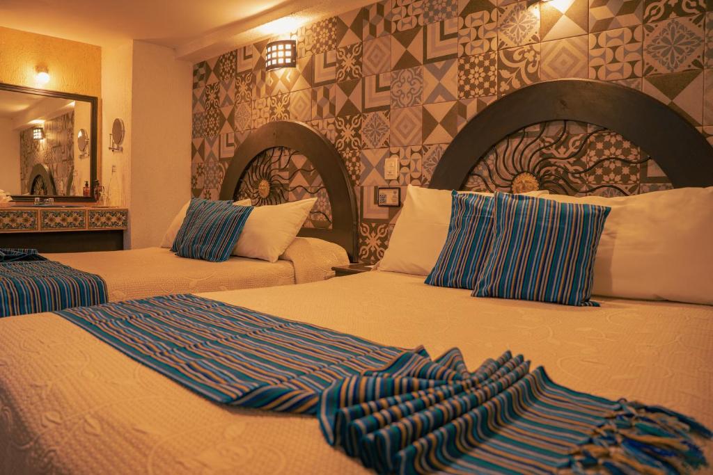 Postel nebo postele na pokoji v ubytování Hotel Tepeyac