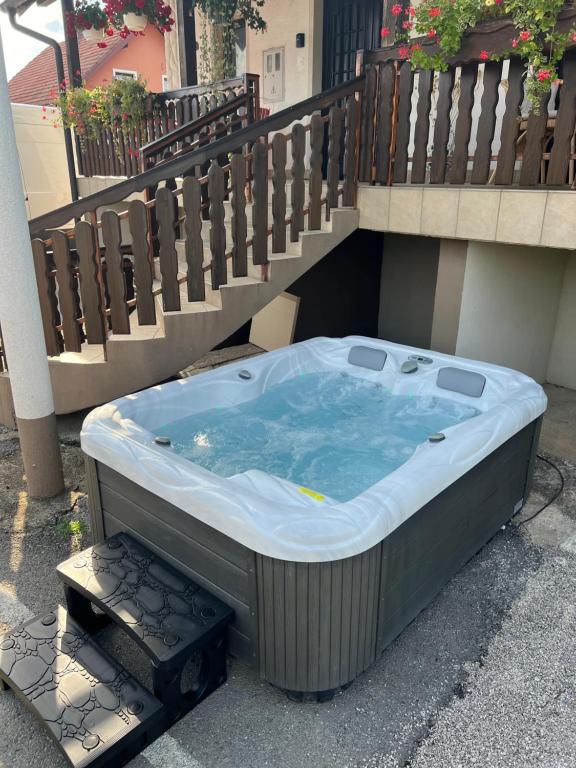a jacuzzi tub sitting under a balcony at Anamarija Apartments in Ličko Petrovo Selo